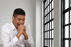 Man laughing and covering his mouth