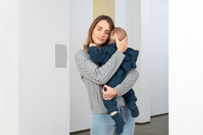 A woman holding a baby in her arms