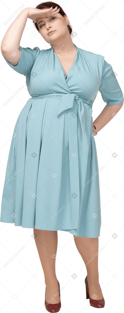 Front view of a woman in blue dress looking for someone