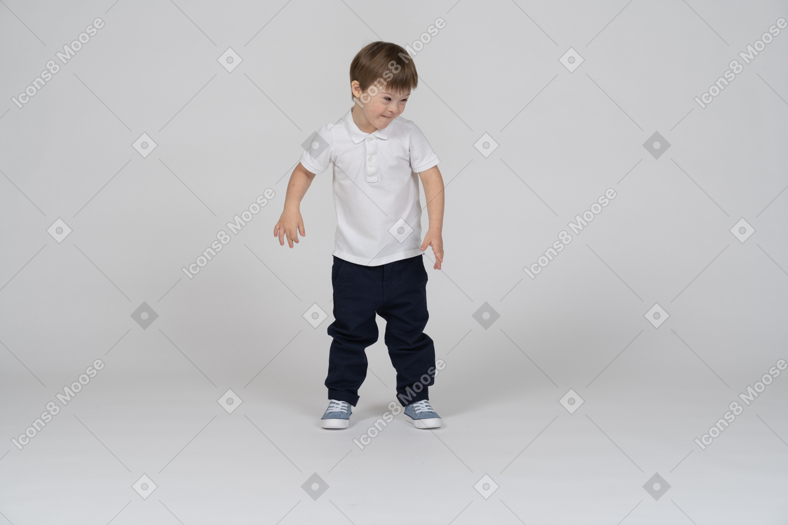 Smiling little boy standing and looking aside
