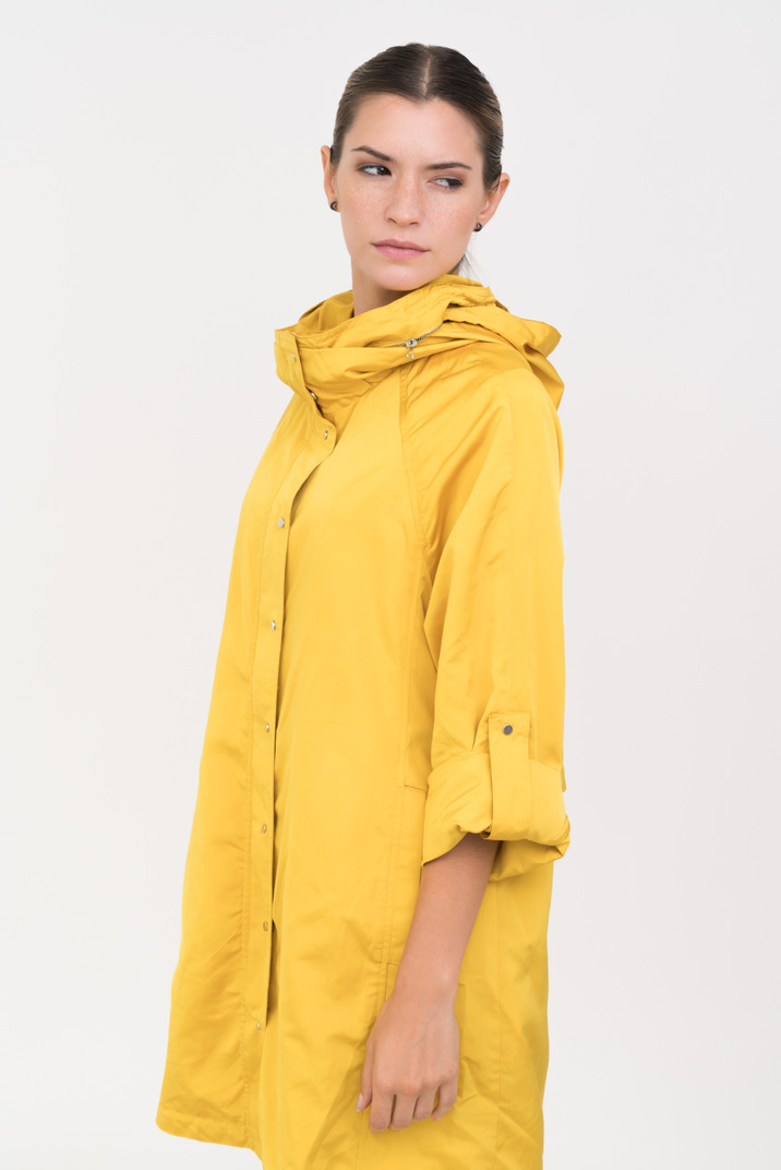 Woman in yellow anorak standing