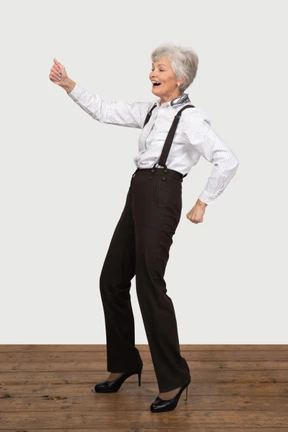 Laughing businesswoman dancing