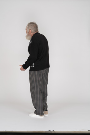 Three-quarter back view of an old man slouching slightly