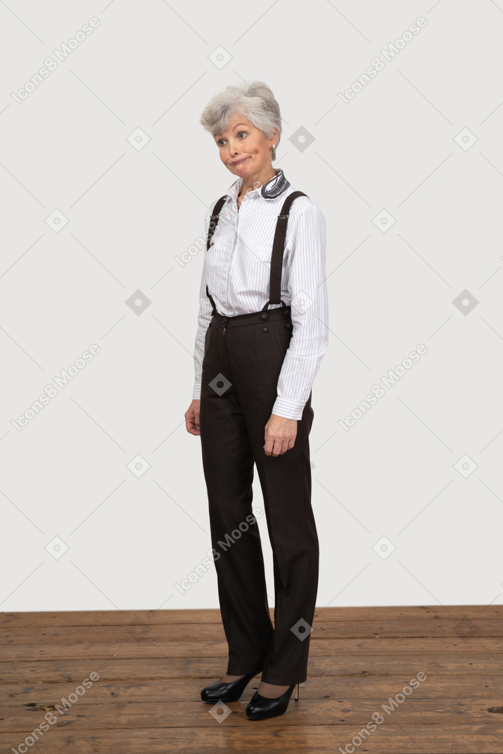 Three-quarter view of a perplexed old woman in office clothing
