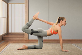 A woman doing a yoga pose in a room