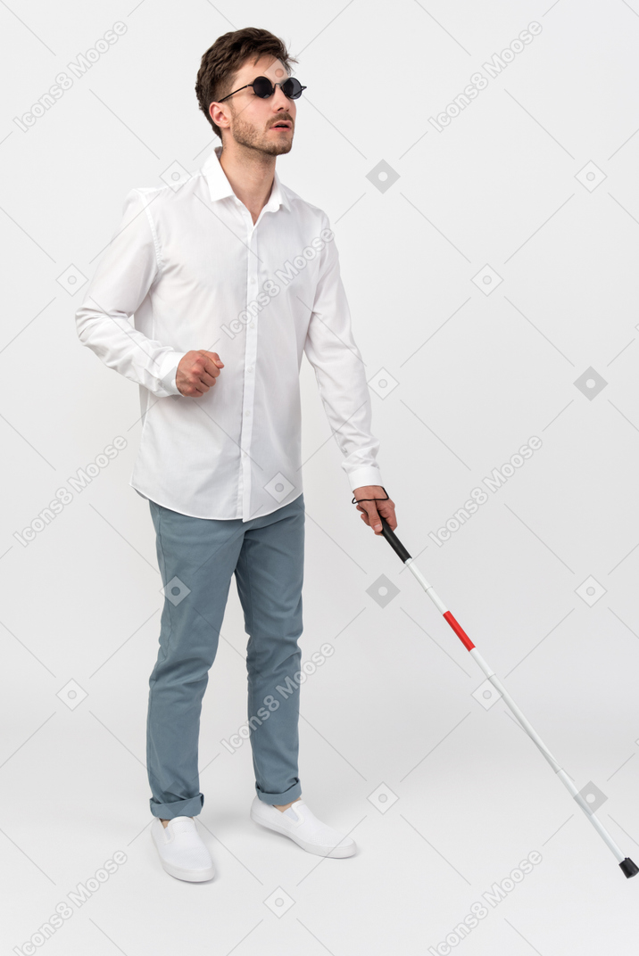 Blind man using a white cane