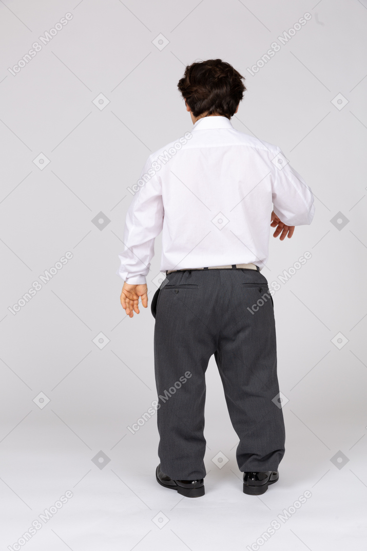 Back view of a young office worker raising his hand