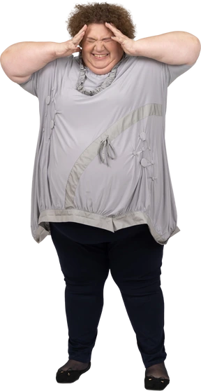 Smiling woman holding her head