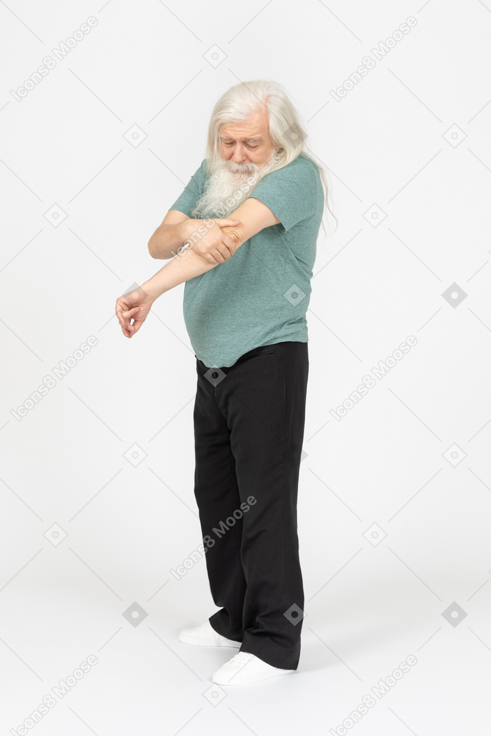 Three-quarter view of old man feeling pain in elbow