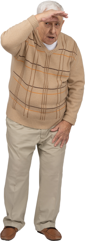 Front view of an old man in casual clothes looking for someone