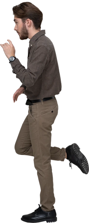Side view of a young man in office clothing raising leg