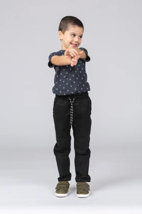 Front view of a happy boy standing with extended arms
