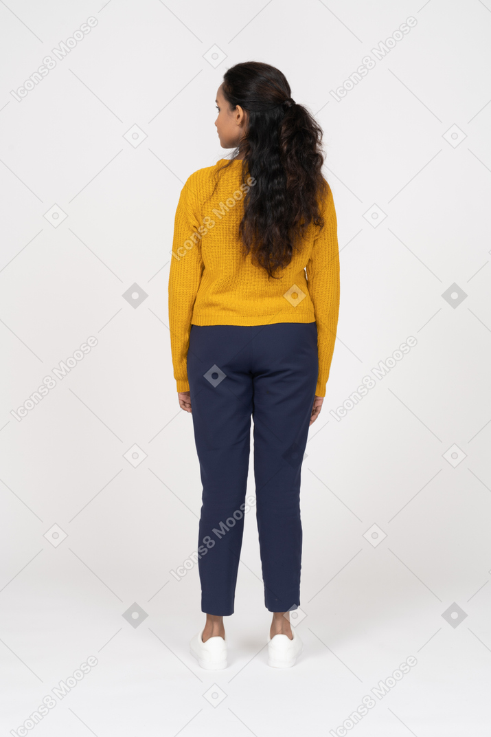 Rear view of a girl in casual clothes looking aside