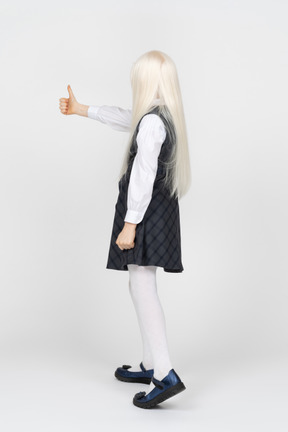 Back view of a schoolgirl giving thumbs up