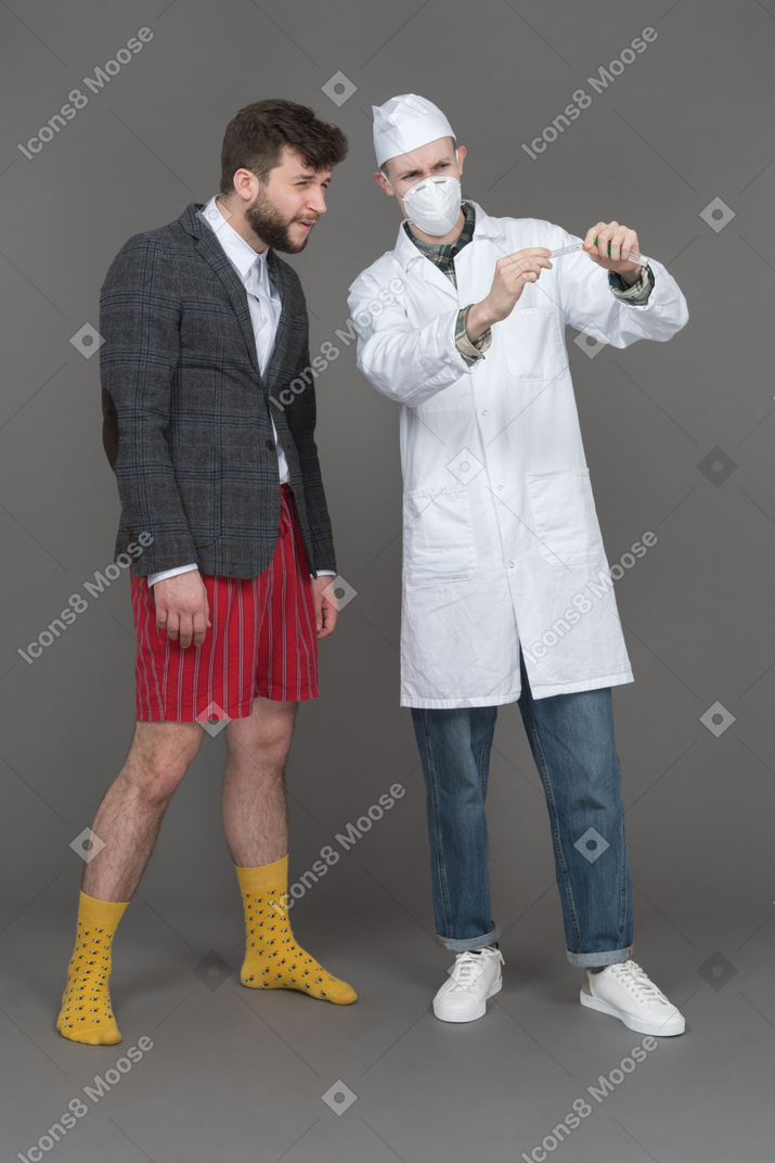 Young man and doctor looking at the results