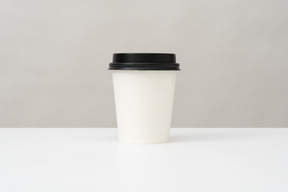 Plastic cup for hot drinks with a lid