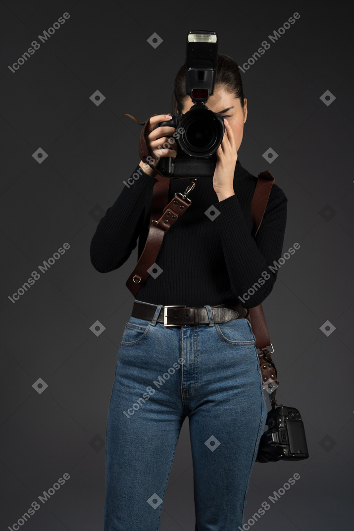Young female photographer taking picture