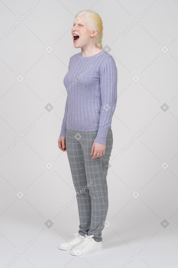 Woman in casual clothes standing with her mouth wide open