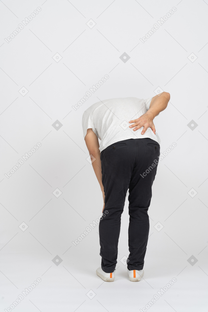 Back view of a man suffering from back pain