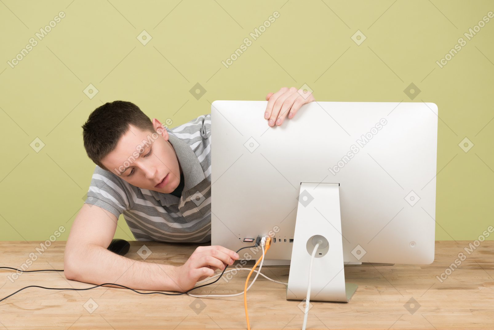 Man putting a computer cable into a socket