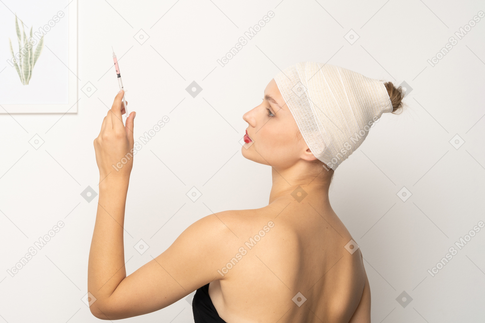 Side view of a young woman holding up syringe