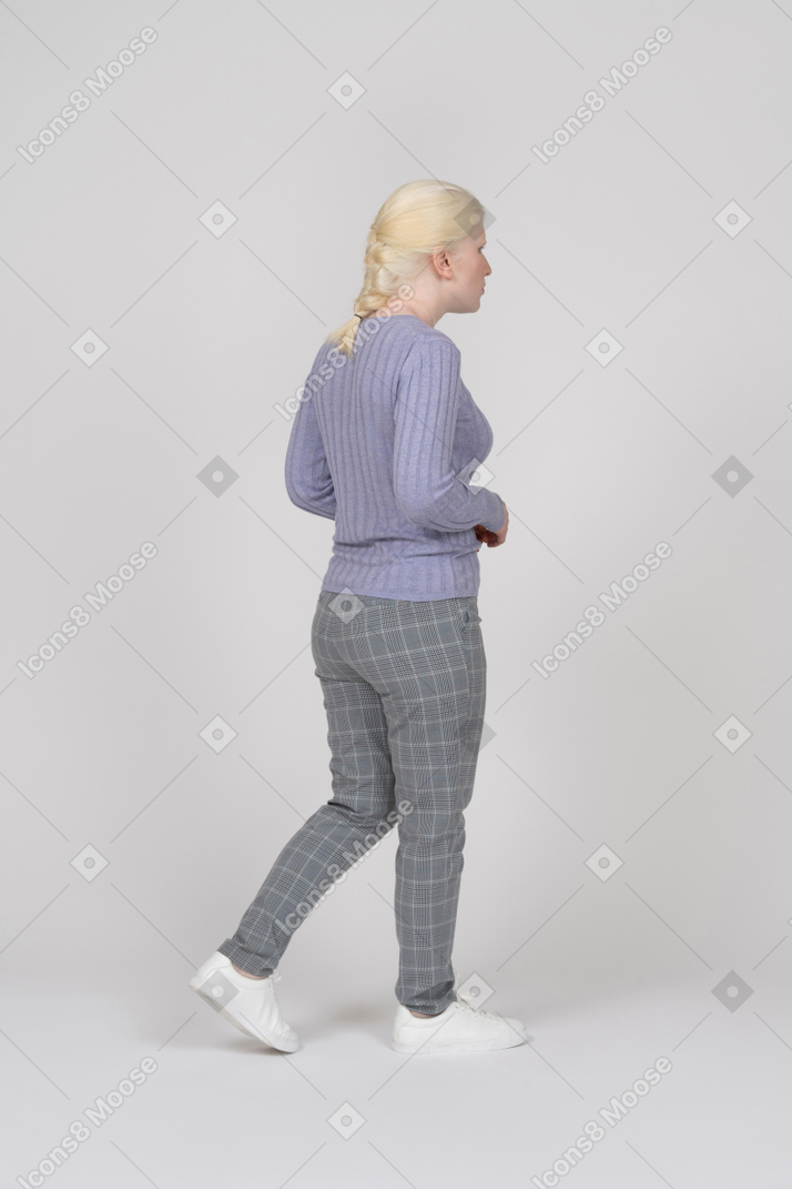 Young woman walking and looking away