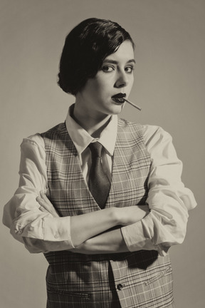 Elegant young woman in formalwear facing camera with folded hands