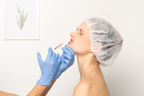 Frau rümpft ihre nase während einer botox-injektion
