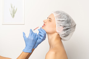 Woman scrunching up her nose during botox injection