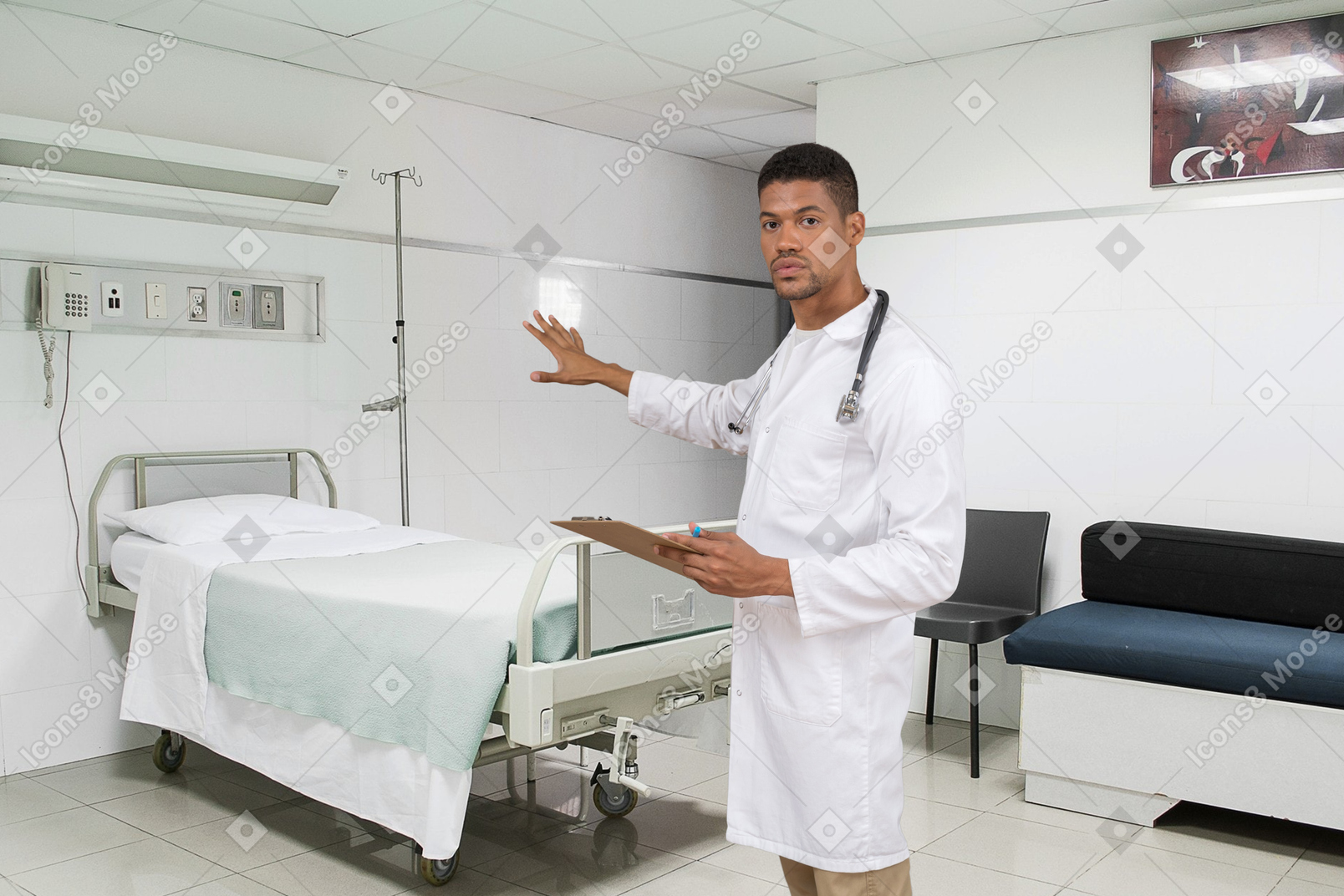 A male doctor standing next to a bed in a hospital room