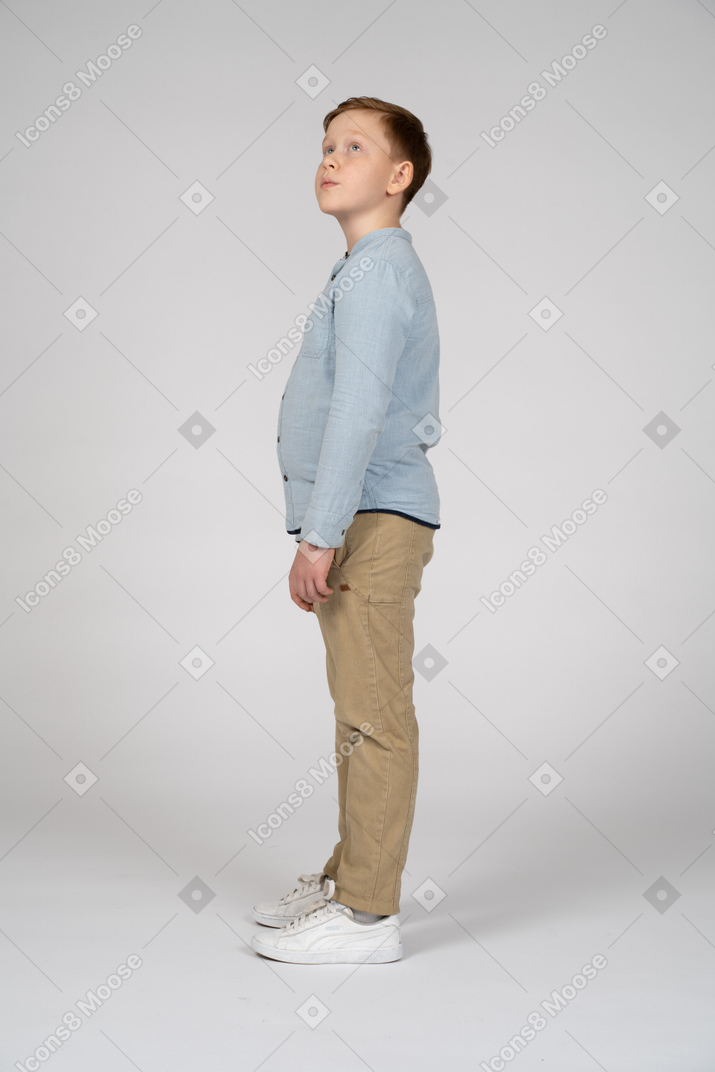 Side view of a cute boy looking up