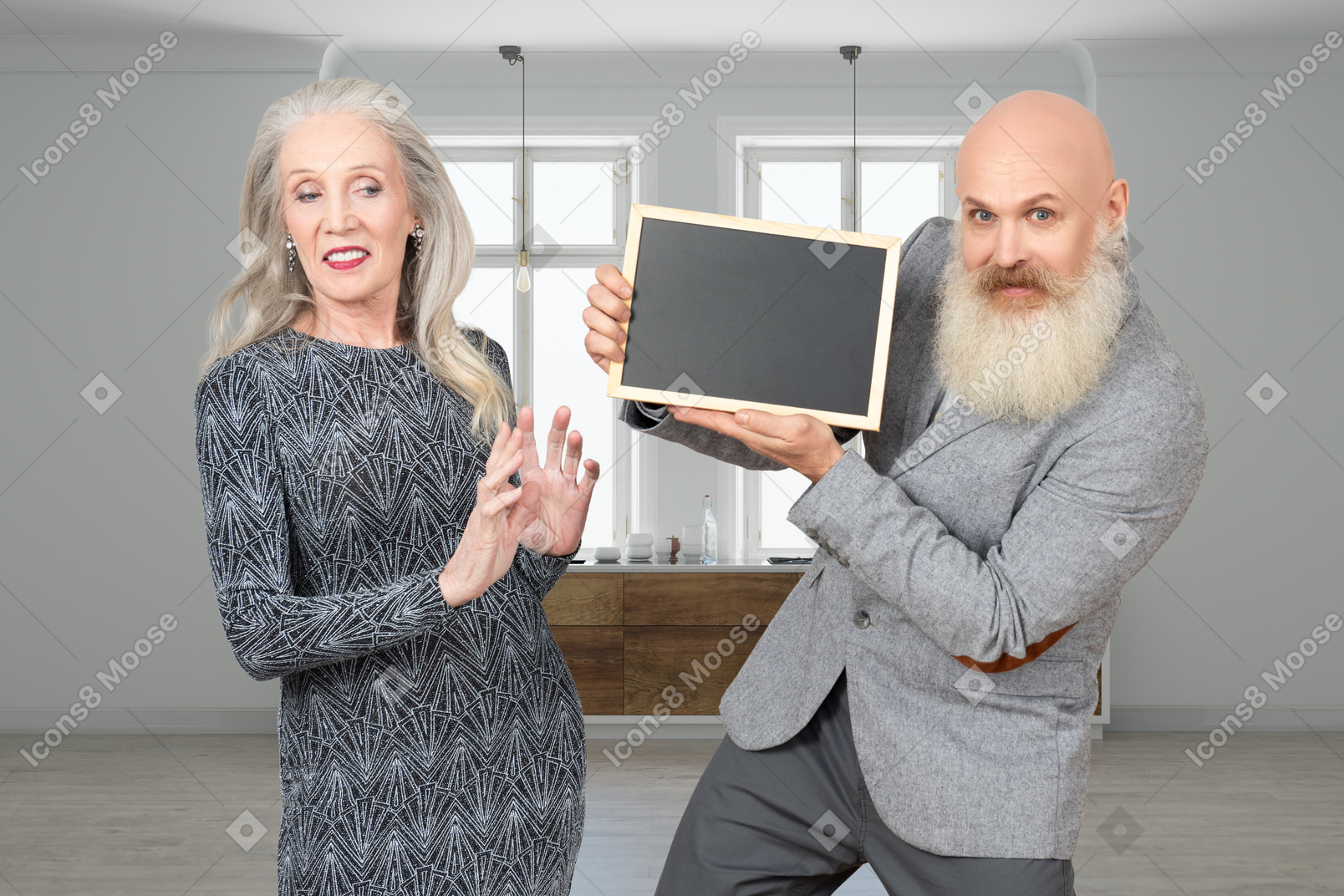 A man with a beard and a woman holding a blackboard