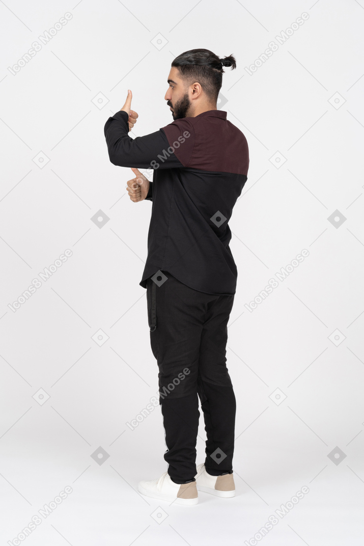 Side view of man showing two thumbs up