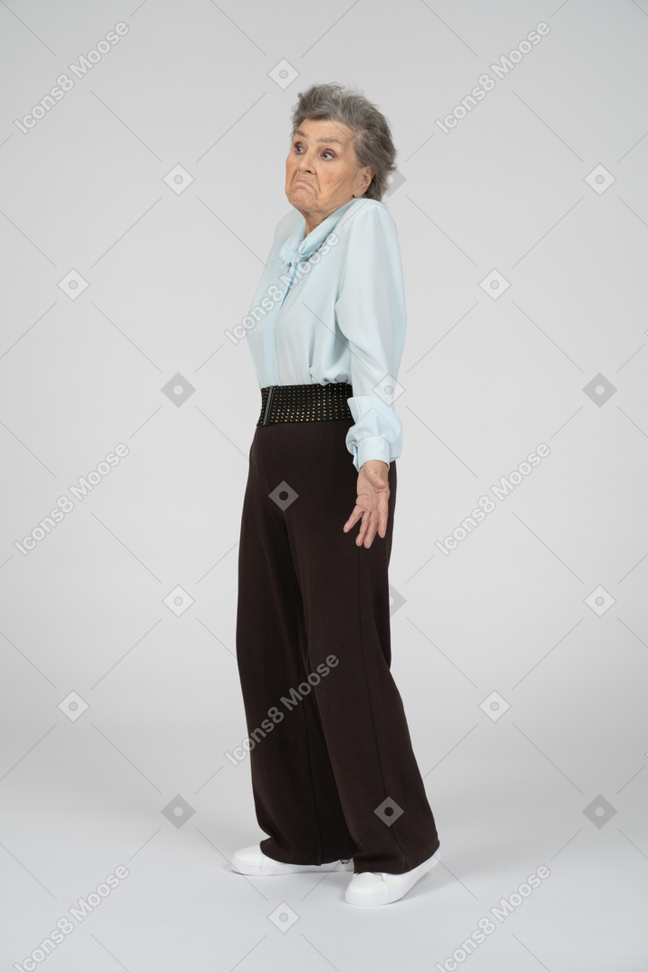 Side view of an old woman shrugging