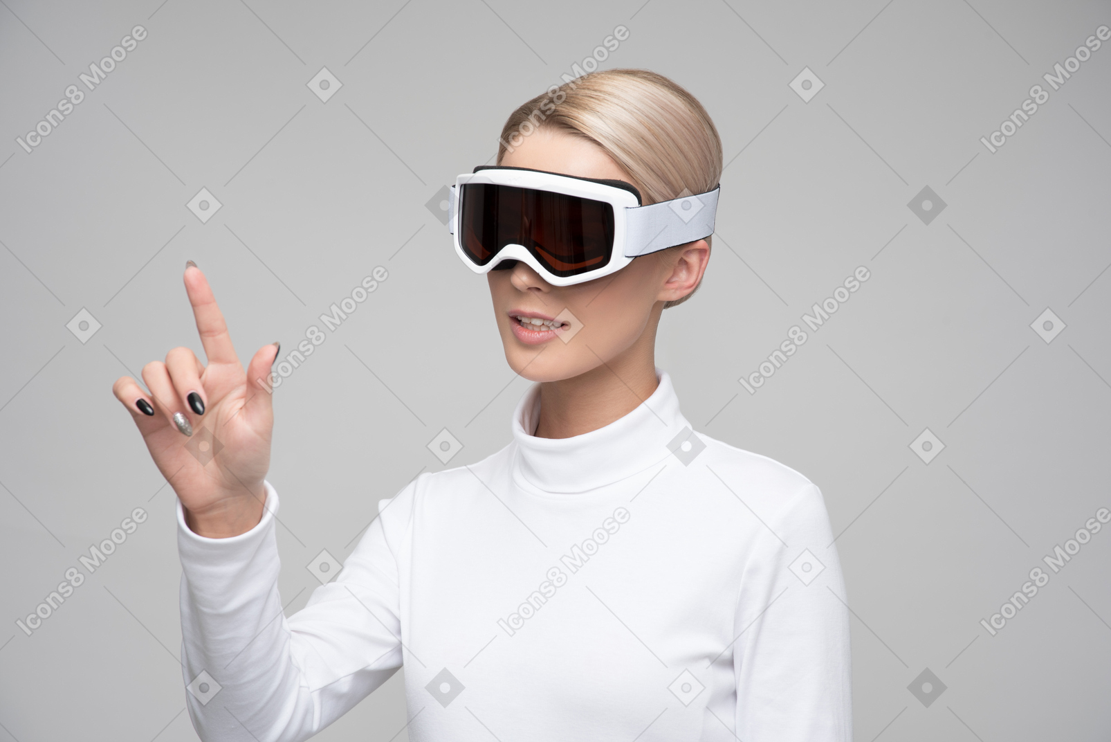 Young blonde woman in ski goggles