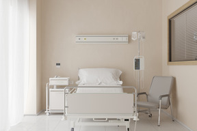 Hospital room with comfortable bed and armchair