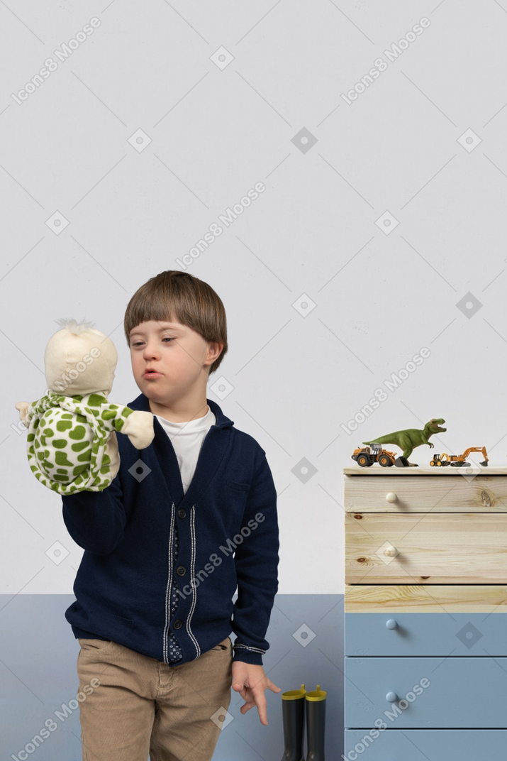 Little boy playing with his turtle puppet