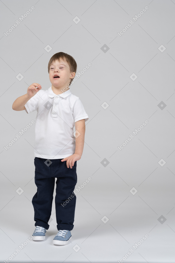 Front view of little boy sneezing