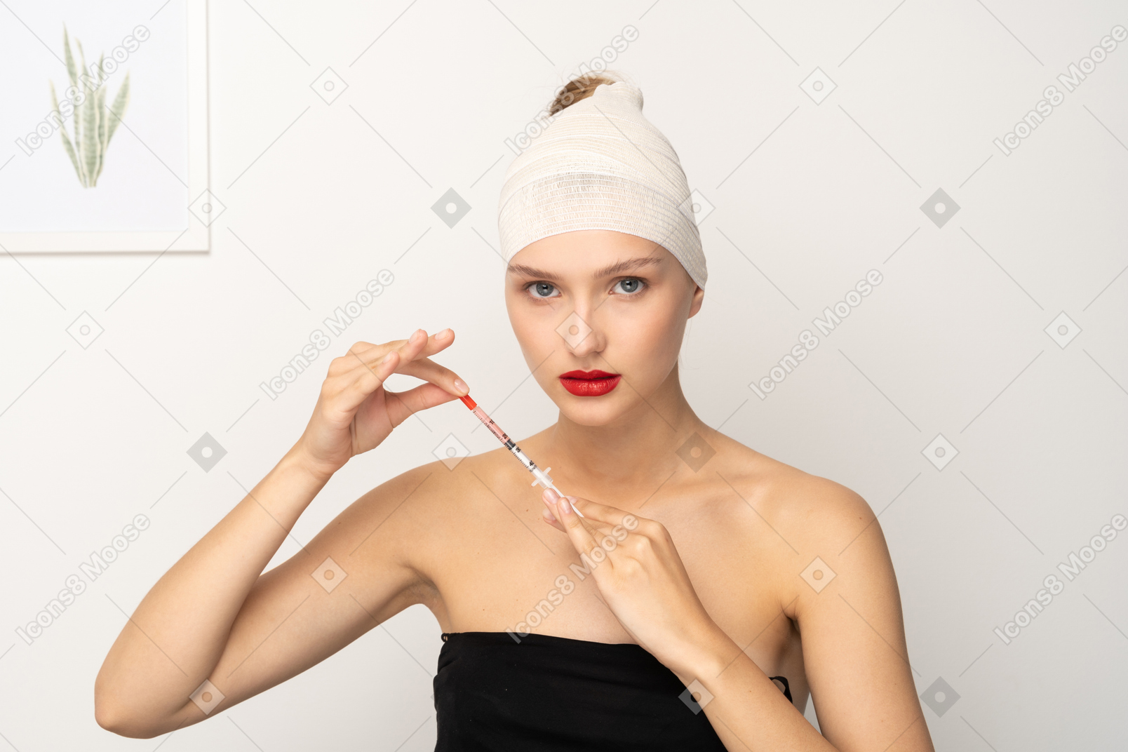 Young woman with bandaged head holding syringe