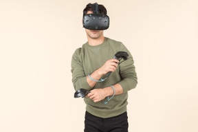 Young caucasian guy playing a virtual reality game