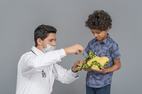 Doctor injecting a toy