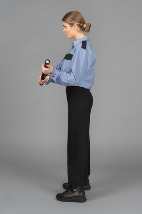 Female security guard with a baton in hands