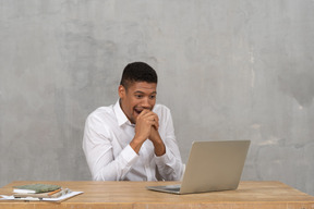 Young man covering his mouth