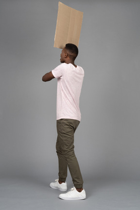 African man holding a poster backwards to camera