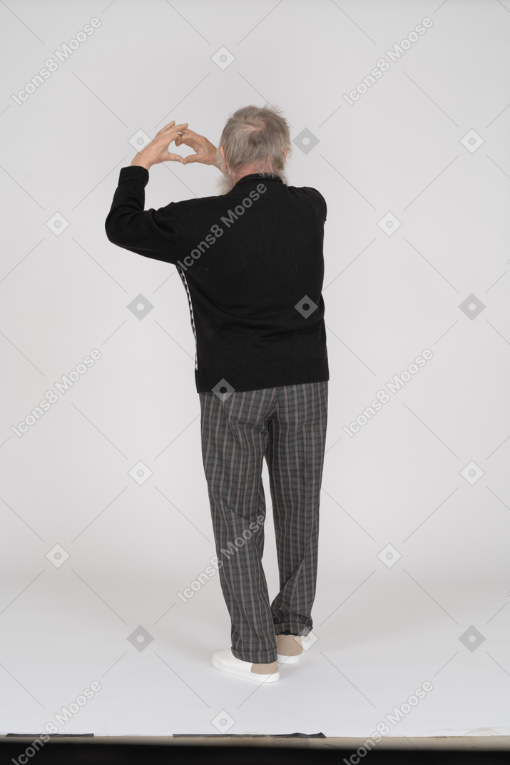Back view of old man showing love gesture