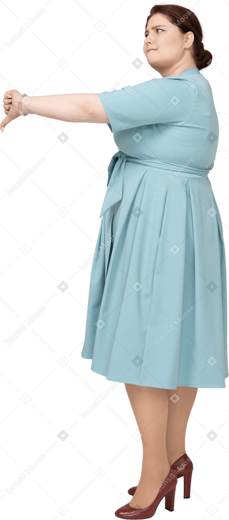 Side view of a woman in blue dress showing thumb down