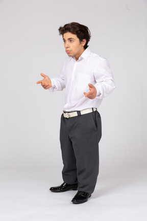 Three-quarter view of a man in formalwear arguing and gesturing