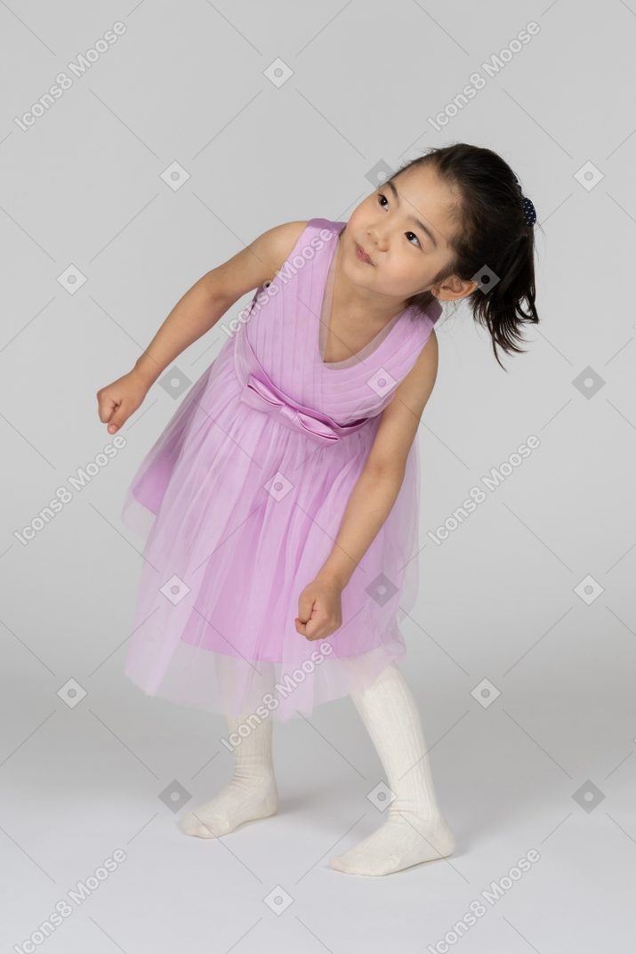 Girl in a pink dress bending