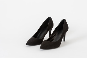 A three-quarter front shot of a pair of black stiletto high heels