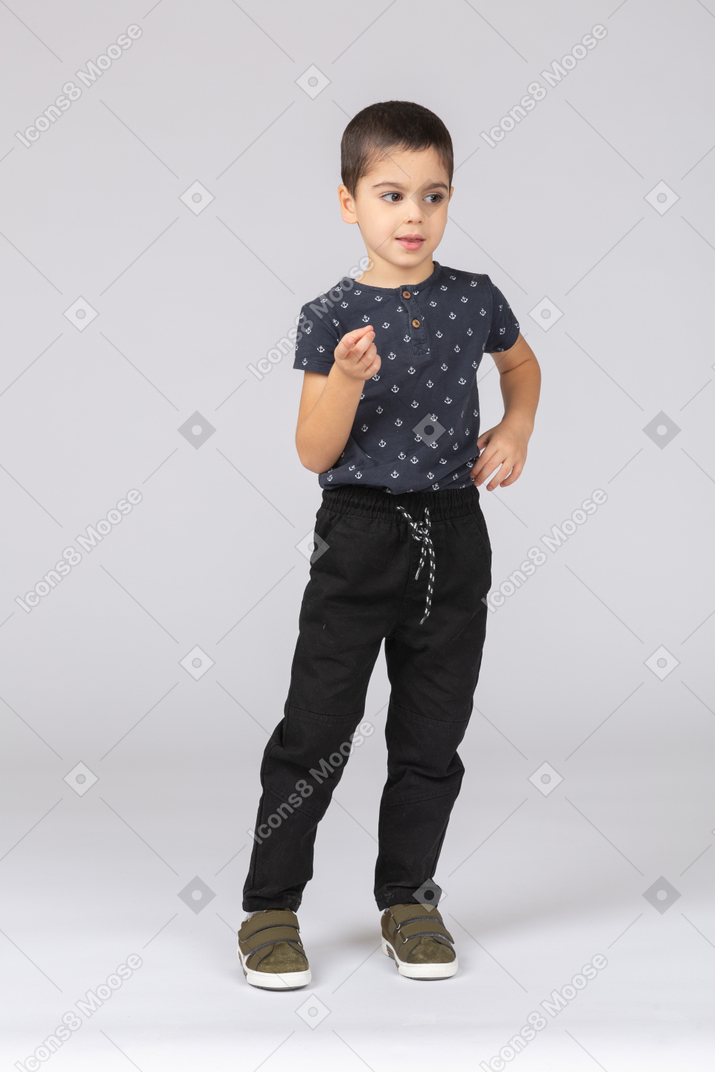 Front view of a cute boy pointing at camera